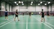 © Kembar - Blurred badminton players indoor court