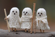 © Jiranun - Cute Halloween ghost dolls made from yarn and wooden sticks.