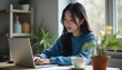 © 말랑콩이 놀이공작소 - A young Korean woman with long black hair, wearing a casual blue sweater, sitting at a wooden desk in a sunlit home office, typing on a laptop
