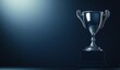 © wilson - Shiny silver trophy on dark blue background perfect for showcasing success of award or competition winner highlighting beauty texture creating gentle shadows accentuating sleek design