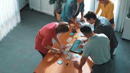 Time lapse of manager writing idea on sticky note and explain idea about web design. Professional marketing team or programmer brainstorming idea while looking at tablet with color palette. Symposium.
