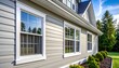 © Bagas - Exterior of a house with gray siding and white trim