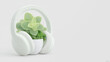© Dionisia - White headphones complement a small potted plant, ideal for music lovers, gardeners, or tech enthusiasts in need of a fresh cover image.