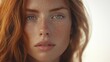© Gendut - Close-up portrait of a young woman with freckles and red hair.