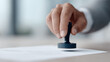 © SolaruS - Closeup of a hand stamping a document, representing approval, authority, or validation. Suitable for business, legal, or administrative contexts.