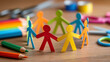 © Elif Taran - Colorful paper people holding hands in circle with school supplies