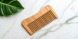 Eco friendly bamboo hair comb styled on marble surface in natural reusable sustainable design