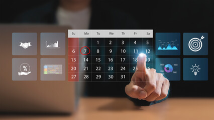 Calendar for monthly appointments and planning, Managing his business schedule, Hand marking dates on virtual calendar	