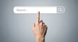 © dayinta - Hand pointing at a search bar on a gray background.