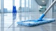 © backup_studio - Blue mop cleaning a shiny tile floor in a modern hallway, concept of clean environment and hygiene for home