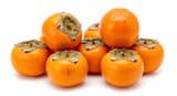 A vibrant pile of ripe, orange persimmons with green calyxes, isolated on a clean white background. Fresh and healthy fruit, perfect for a nutritious snack.