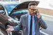 © Dragana Gordic - Businessman Making a Phone Call Next to a Broken Down Car