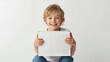 © Renat - Blond european 10 year old boy holding empty gift. Happy kid with present. Mockup. White background.