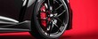© Jonathan - Close-up of a sports car wheel with sleek black rims and red calipers- showcasing luxury and performance automotive design.