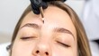 © Arnol - Woman receiving eyebrow microblading (2)