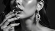 © NARUMOL - Elegant portrait of woman with striking earrings and polished nails, showcasing beauty and sophistication in monochrome tones