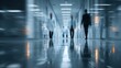 © HQ2X2 - Blurred people walking in modern hospital corridor