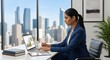 © Newly - Businesswoman working on laptop in modern office with city skyline view