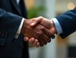 © Avinash - Close-up of a professional handshake between two diverse businessmen, sealing a successful partnership agreement in a corporate setting