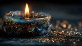 Glowing Candle Flame with Golden Sparkles on Dark Blue Background
