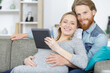 © auremar - attractive happy young man and pregnant woman holding digital tablet