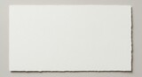 Blank textured white paper with torn deckled edges on neutral background, perfect for copy space or minimalist design.
