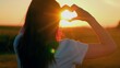 © Victoriia - Healthy heart. Happy girl makes a heart with her fingers nature. Young woman loves travel. Girl made heart from her palms. Symbol of love in hands of teenager girls sun light. Travel, relax in nature