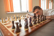 © Михаил Решетников - Middle aged Caucasian man playing chess.