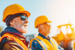 © Maksym - Senior construction engineers in helmets supervising building site