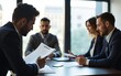 © wu - Profile view of a businessman doing case study with documentation while sitting with colleagues at conference room. High quality