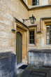 old green door and lamp in one of Oxford University college's alleyways
