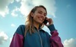 © ming - Low angle view of smiling trap girl in tracksuit standing and having phone call with a friend. High quality