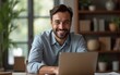 © lan - A happy businessman having and online meeting with coworkers from his cozy home. High quality