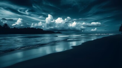 Wall Mural - Moody Night Beachscape - A serene night beach view with a dramatic cloudy sky reflecting over the gentle waves. The deep blue tones create a calming and mystical atmosphere.