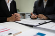© กจรเดช จอมเดช - Business Negotiation with Documents and Pens on Desk