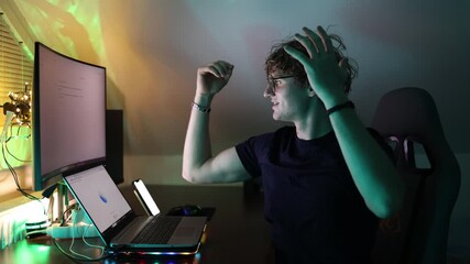 Student celebrates breakthrough while interacting with artificial intelligence glowing monitor and laptop reflect successful digital answer and optimism about future technology