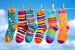 © Robert Kneschke - Colorful socks hanging on a clothesline against a bright blue sky
