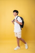 © Q88 - Smiling student with a backpack walking towards a bright future with optimism and enthusiasm