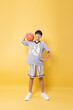 © Q88 - Young athlete poses with basketball ready for the game showcasing youth sports and recreation