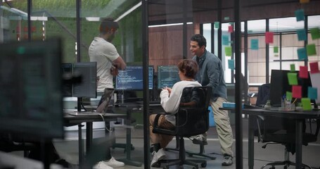 Creative Team of Diverse Specialists Having a Conversation at a Workplace Next to Computer. Two Male Software Engineers and a Female Developer Discussing a Software Code for Their Digital Project