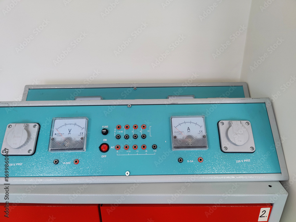 Vintage control panel with dials and meters on a red cabinet ...