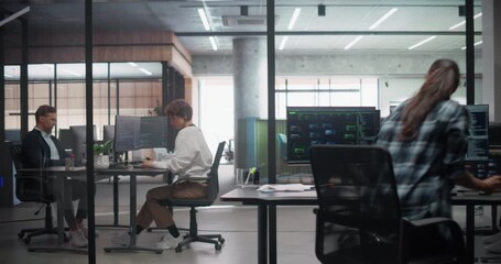 Male and Female Software Developers Working on Technological Projects, Writing Source Code. Office Workplace with Diverse Young People Working Behind Computers, Manager Walking with a Tablet