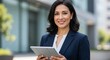 © Arx PhotoStock - Smiling businesswoman holding tablet corporate portrait professional confident success