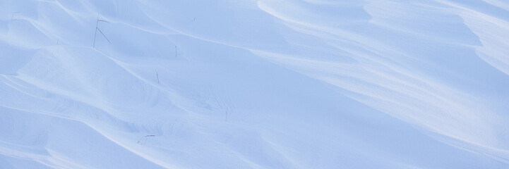 Wall Mural - Snow texture. Wind sculpted patterns on snow surface. Wind in the tundra and in the mountains on the surface of the snow sculpts patterns and ridges. Arctic, Polar region. Winter panoramic background.