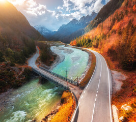Wall Mural - aerial view of winding mountain road at sunset in autumn. alps, italy. alpine road, bridge, river, s