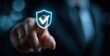 © shuai - Technology computer and internet cyber security and anti virus concept, Businessman pressing security shield with check mark icon with blurred office background. High quality