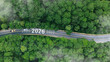 © Deemerwha studio - Aerial top view road in forest with car to start the new year 2026 Goal plan action, Business target and growth strategy. Business annual plan and development for achieving goals and success.