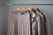 © Роман Булатов - A modern closet showcases a pleated skirt alongside three leather jackets, creating an appealing and trendy outfit selection Generative AI