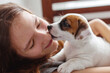 © Tatyana Gladskih - Woman Playing with cute Puppy Dog at home