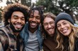 © DesignByGade - Diverse group of friends take a selfie outdoors, smiling brightly.